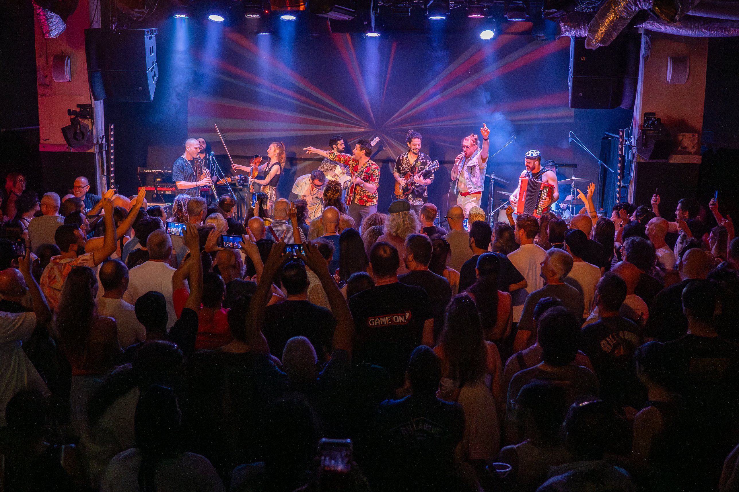 YUZ and the full band on stage, crowd with hands up